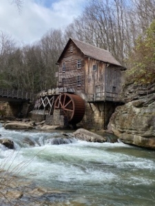 Image of the Grist Mill on Glade Creek in Babcock State Park. The photo is taken from below the mill with the creek flowing below.