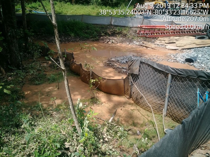 Image of a barrier wall along the Mountain Valley Pipeline. Water is flowing over the wall.